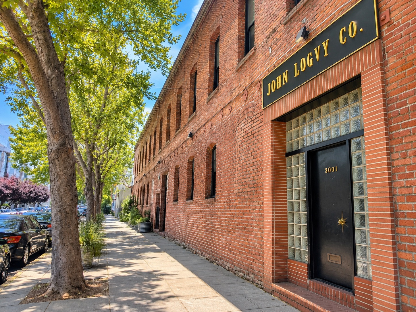 Mission Robotics — brick facade and street trees in the Mission